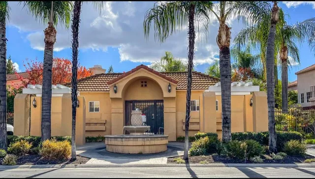 a front view of multiple houses with tree s