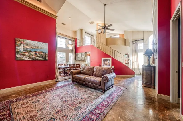 a living room with furniture and a chandelier