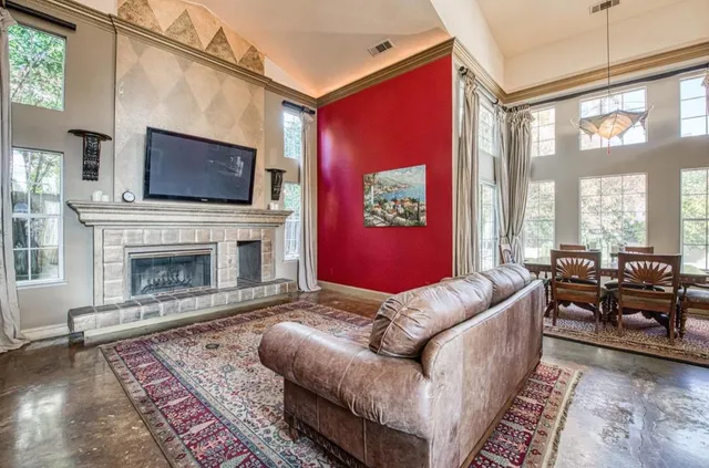 a living room with furniture fireplace and flat screen tv