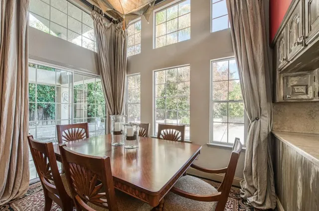a dining room with furniture a chandelier and wooden floor