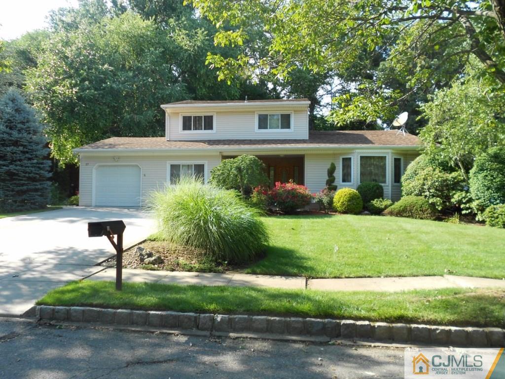 27 Thomas Road East Brunswick, NJ 08816 - Photo 1 of 24 a house view with a garden space