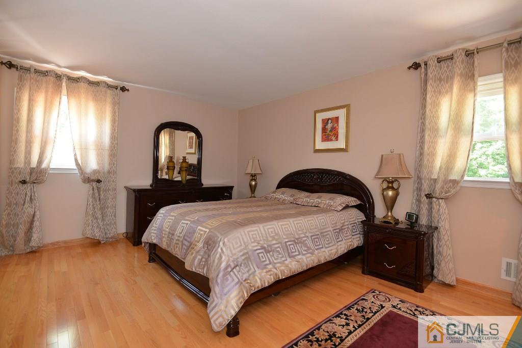 27 Thomas Road East Brunswick, NJ 08816 - Photo 12 of 24 a bedroom with a bed and a closet