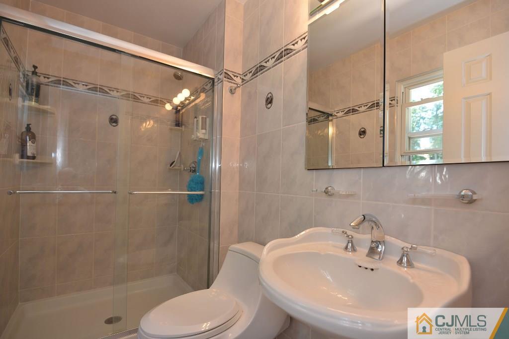 27 Thomas Road East Brunswick, NJ 08816 - Photo 13 of 24 a bathroom with a sink toilet and shower