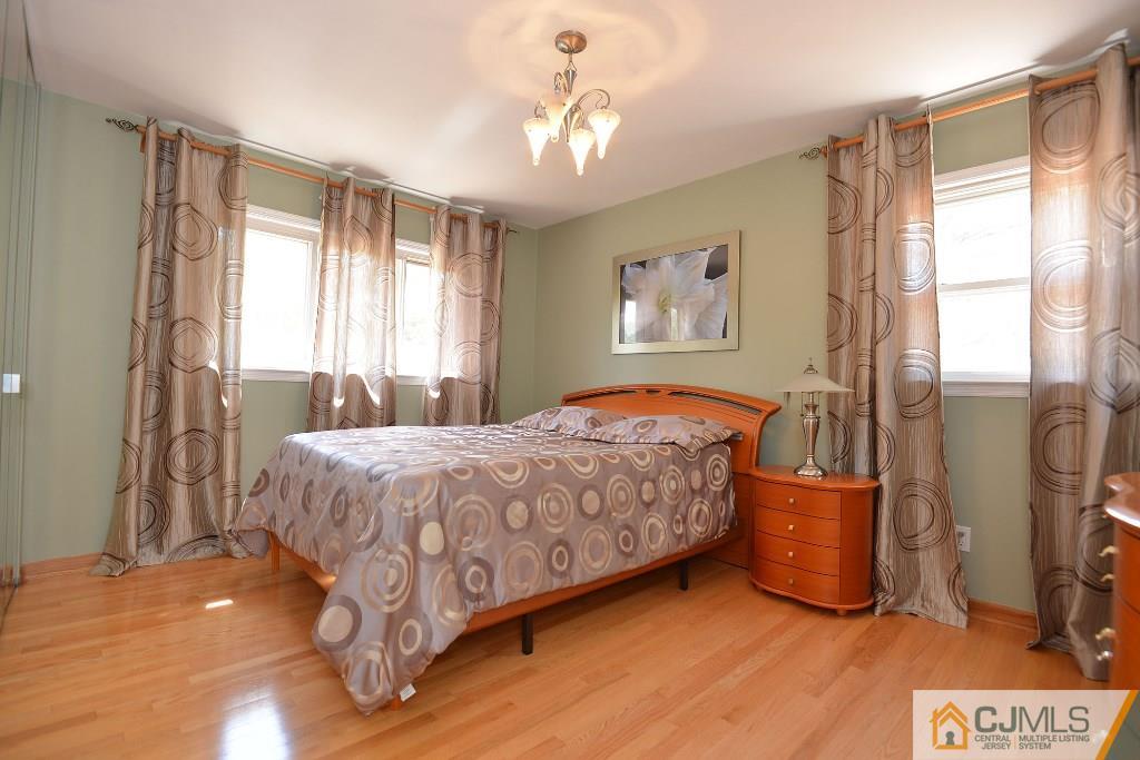 27 Thomas Road East Brunswick, NJ 08816 - Photo 15 of 24 a bedroom with a bed dresser and a window