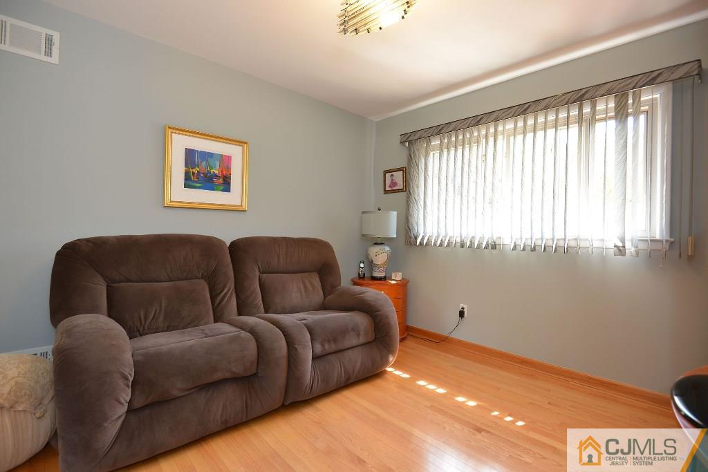 27 Thomas Road East Brunswick, NJ 08816 - Photo 16 of 24 a living room with furniture and a large window