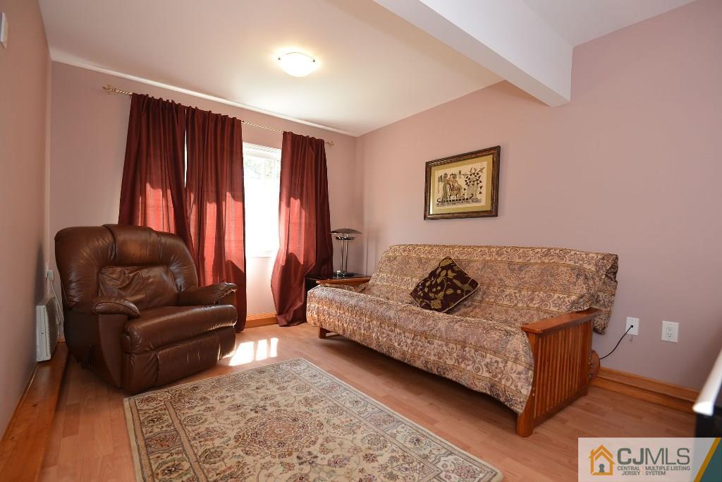 27 Thomas Road East Brunswick, NJ 08816 - Photo 17 of 24 a living room with furniture and a window
