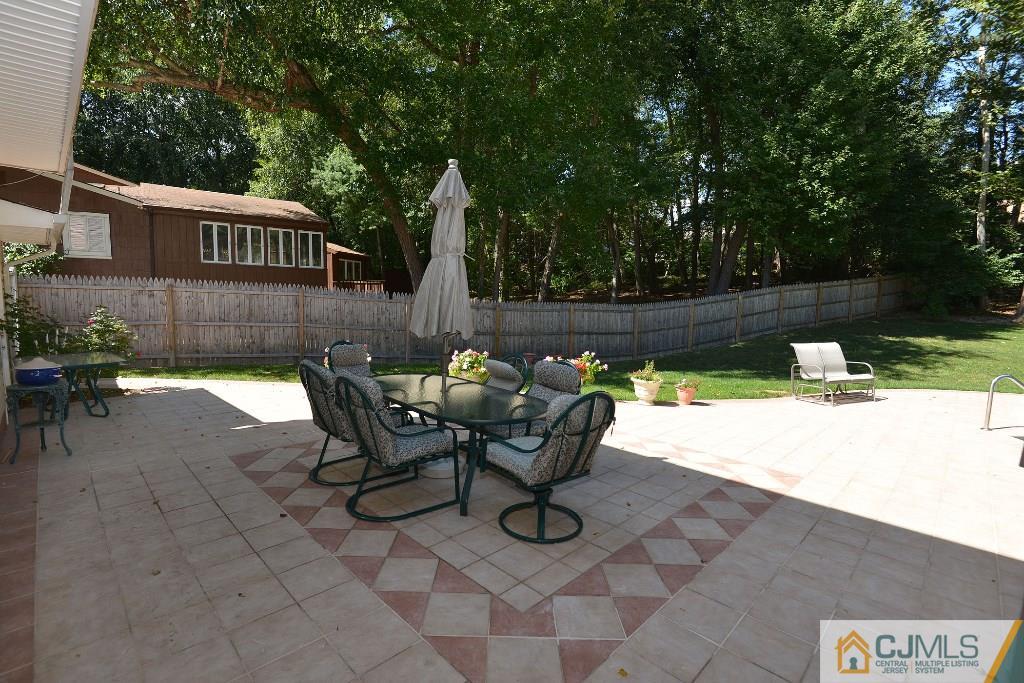 27 Thomas Road East Brunswick, NJ 08816 - Photo 22 of 24 a view of a chairs and table in the patio