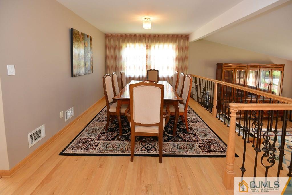 27 Thomas Road East Brunswick, NJ 08816 - Photo 4 of 24 a view of a dining room with furniture window and wooden floor