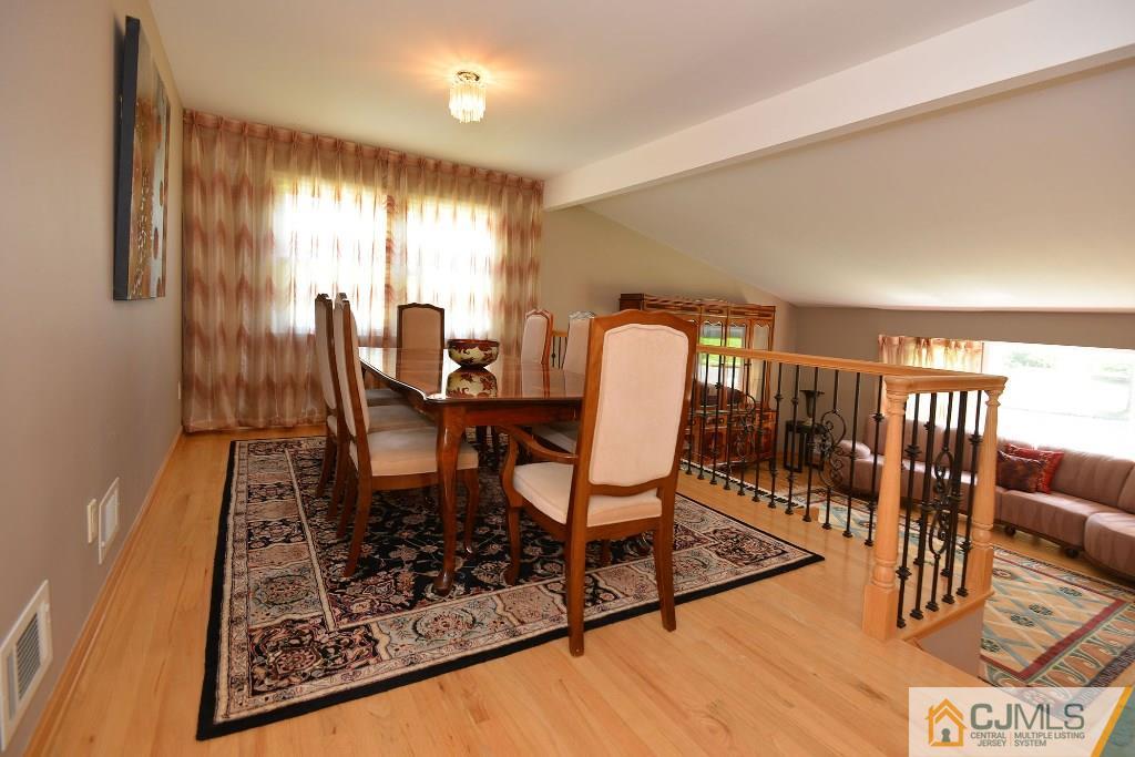 27 Thomas Road East Brunswick, NJ 08816 - Photo 5 of 24 a workspace with furniture a rug and wooden floor