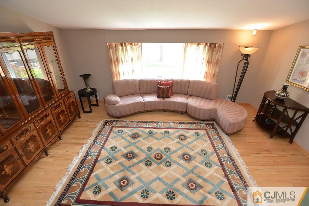 27 Thomas Road East Brunswick, NJ 08816 - Photo 6 of 24 a bedroom with furniture and a flat screen tv