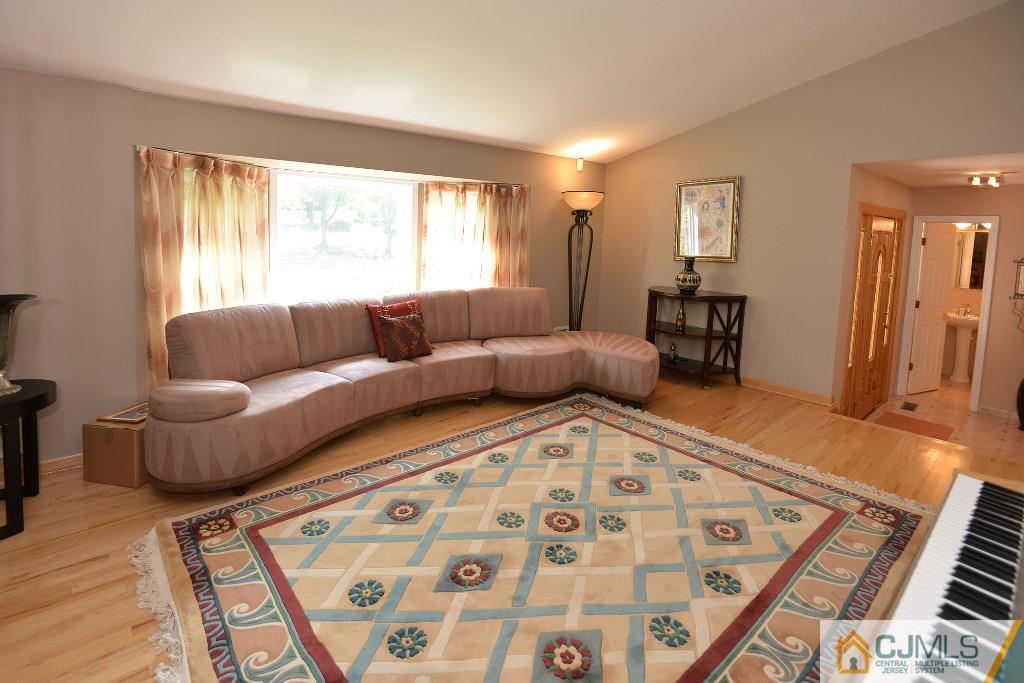 27 Thomas Road East Brunswick, NJ 08816 - Photo 7 of 24 a living room with furniture and a large window