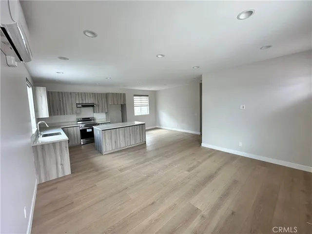 a view of kitchen with sink microwave and refrigerator