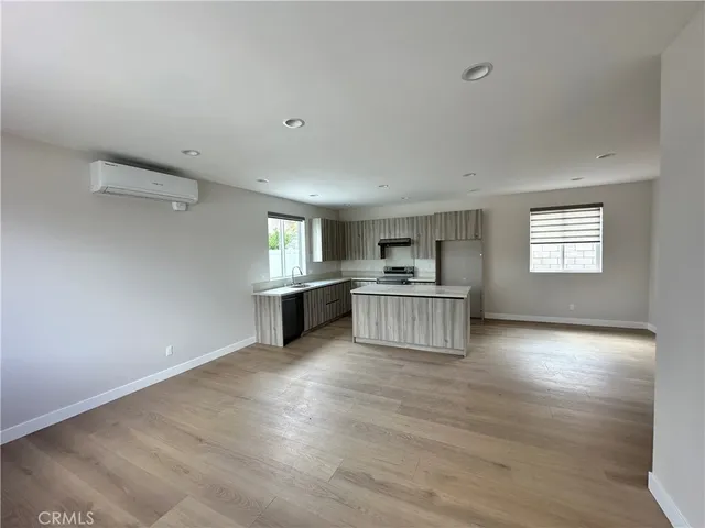a view of kitchen with wooden floor and windows