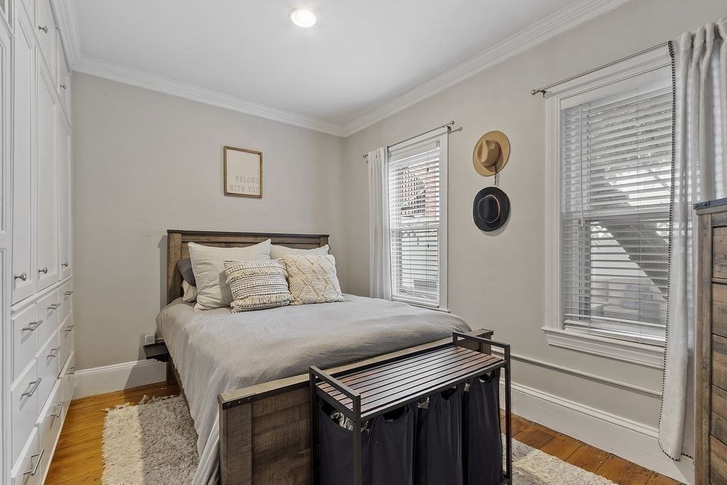 192 West Fifth Street, Unit 1 Boston, MA 02127 - Photo 14 of 24 a bedroom with a bed and cabinets