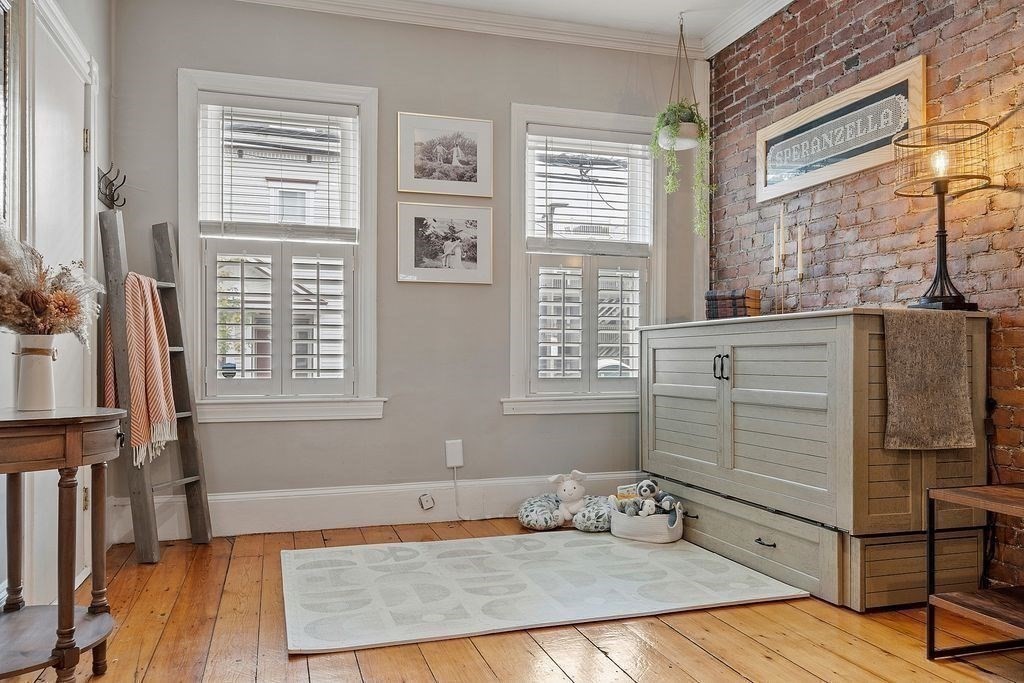 192 West Fifth Street, Unit 1 Boston, MA 02127 - Photo 5 of 24 a bedroom with a bed and wooden floor
