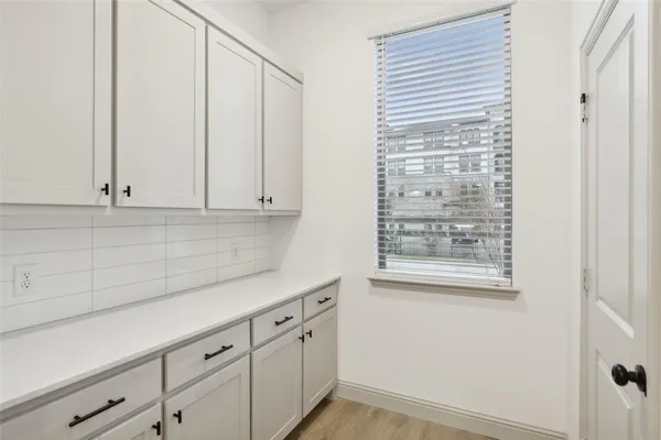 a kitchen with granite countertop cabinets stainless steel appliances and a wooden floor