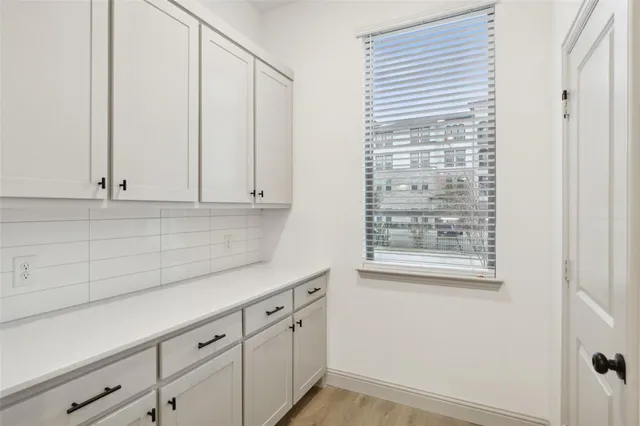 an empty room with a window and a fan
