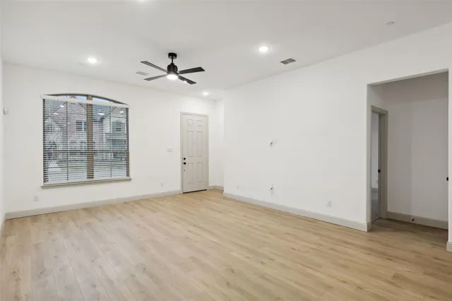 a view of a livingroom with wooden floor and a ceiling fan