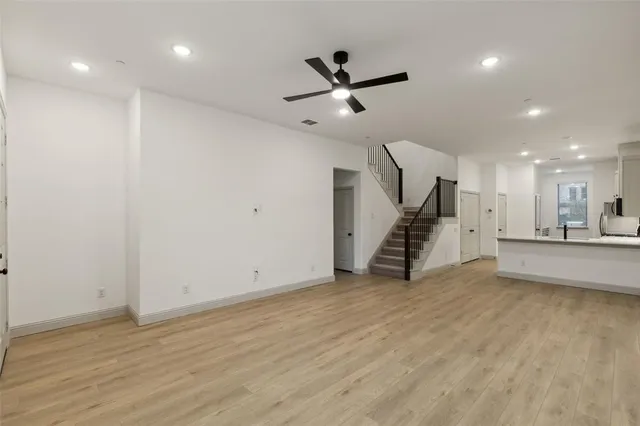 a large kitchen with stainless steel appliances granite countertop a stove and a sink