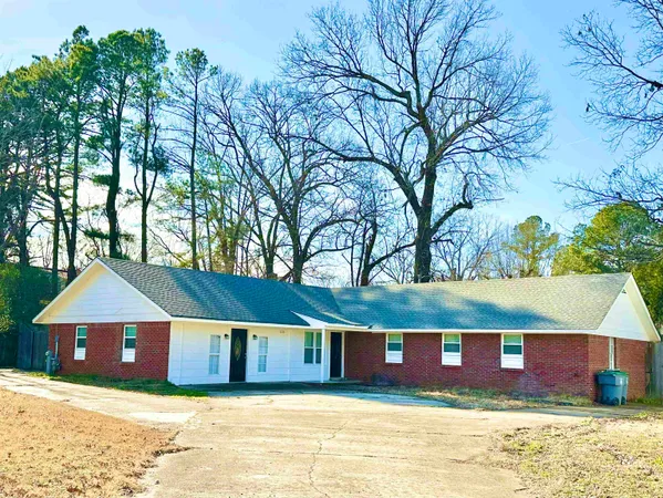 a view of house with a yard and swimming pool