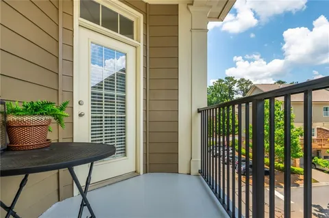 a view of a balcony with a table and chairs