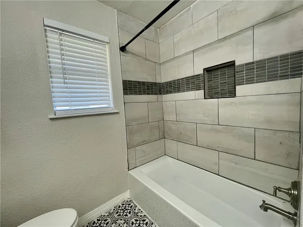 a bathroom with a bathtub and shower