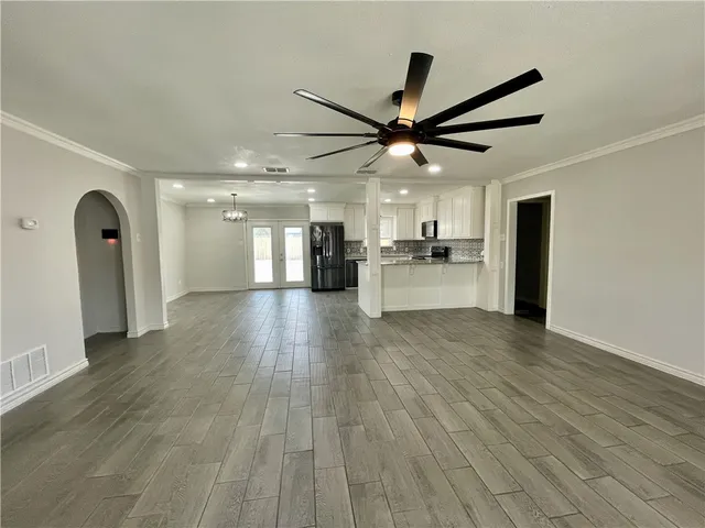 a view of a kitchen with a sink and wooden floor