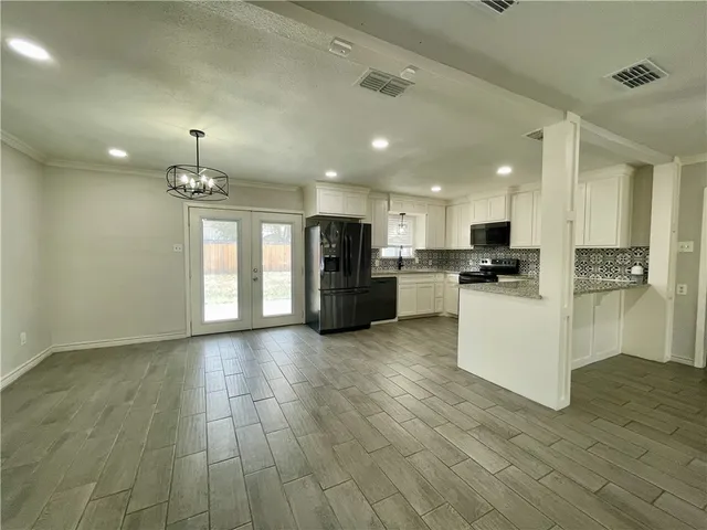 a view of kitchen with refrigerator and window