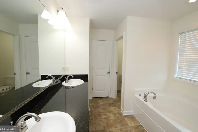 a bathroom with a tub and a sink