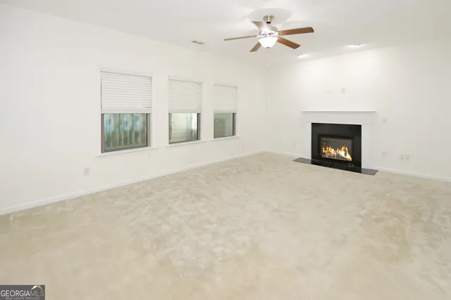 a front view of a house with a garden and trees