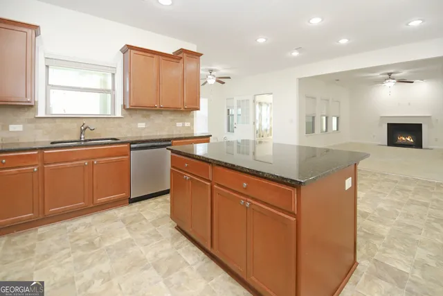 a kitchen with sink cabinets and wooden floor