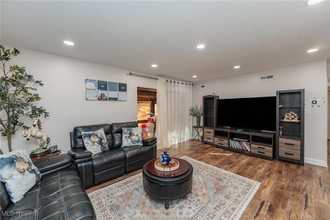 Living area featuring wood finished floors and recessed lighting