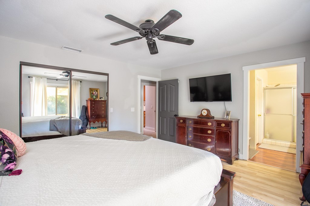 25929 Matlin Road Ramona, CA 92065 - Photo 12 of 19 a bedroom with a bed and a flat screen tv