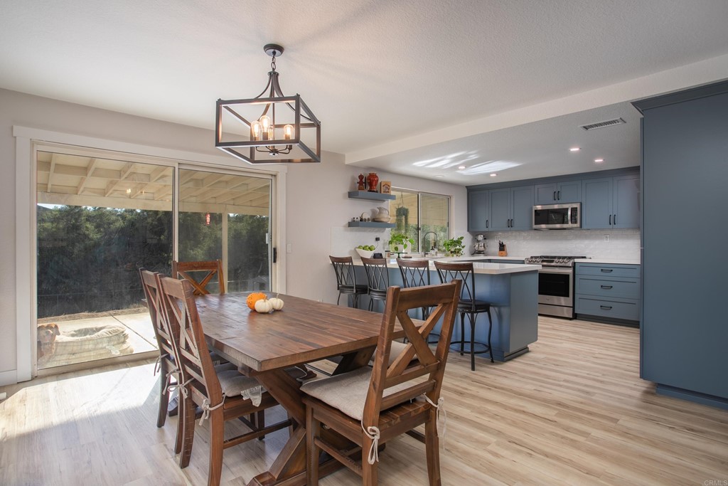 25929 Matlin Road Ramona, CA 92065 - Photo 6 of 19 a view of a dining room with furniture window and wooden floor