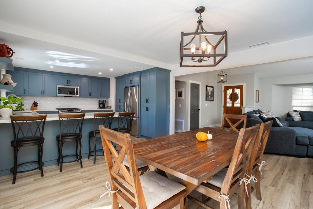 25929 Matlin Road Ramona, CA 92065 - Photo 7 of 19 a view of a dining room with furniture and wooden floor