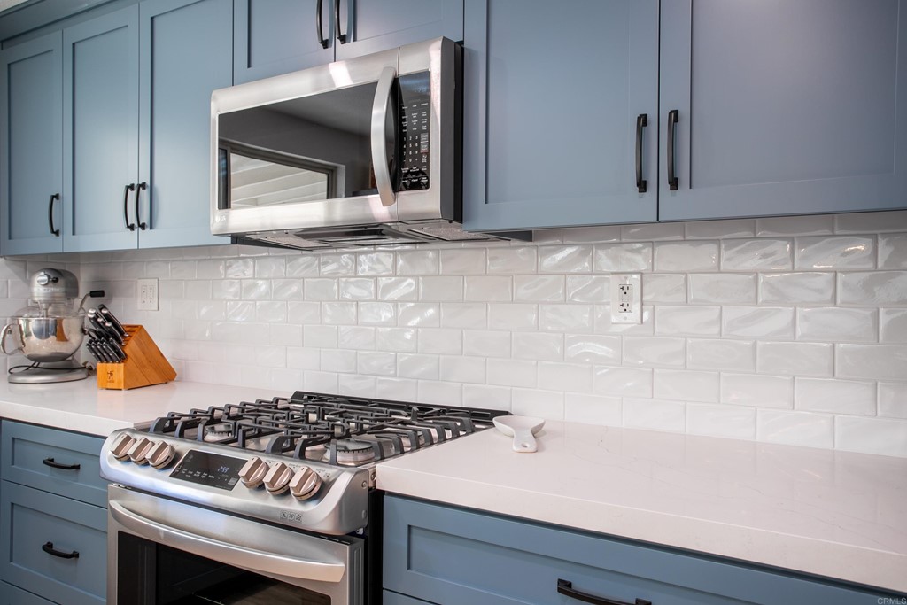 25929 Matlin Road Ramona, CA 92065 - Photo 8 of 19 a kitchen with granite countertop a stove and a microwave