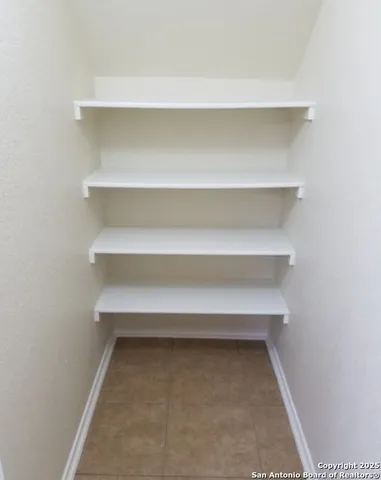 a view of wooden floor and chandelier in a room