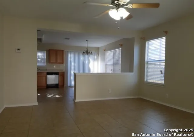 a view of a kitchen with a dishwasher cabinets and a window