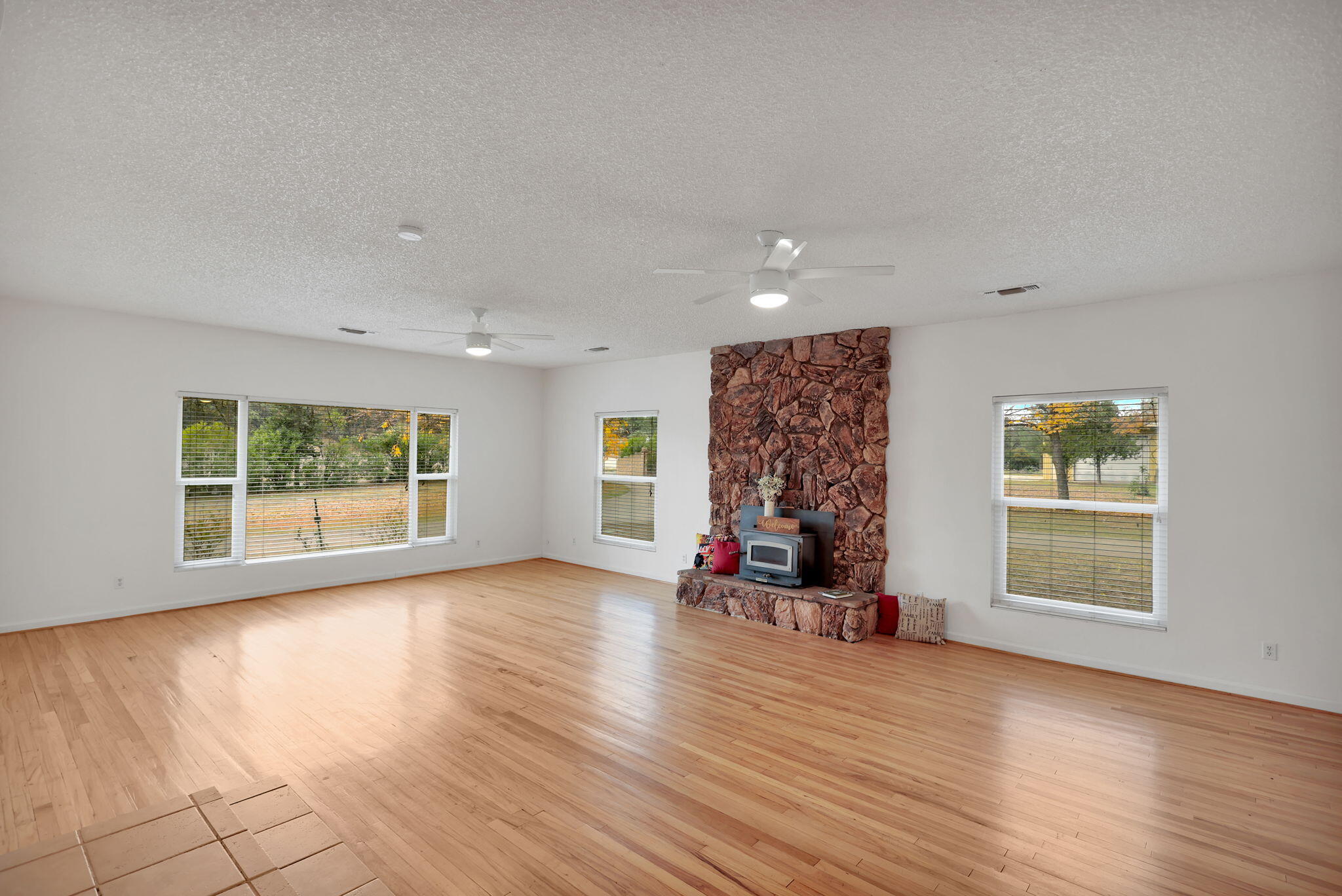 13144 Bear Mountain Road Redding, CA 96003 - Photo 17 of 69 an empty room with wooden floor and windows