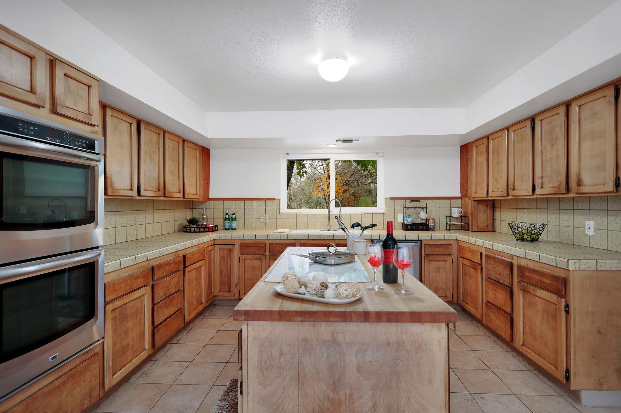 13144 Bear Mountain Road Redding, CA 96003 - Photo 26 of 69 a kitchen with sink cabinets and window