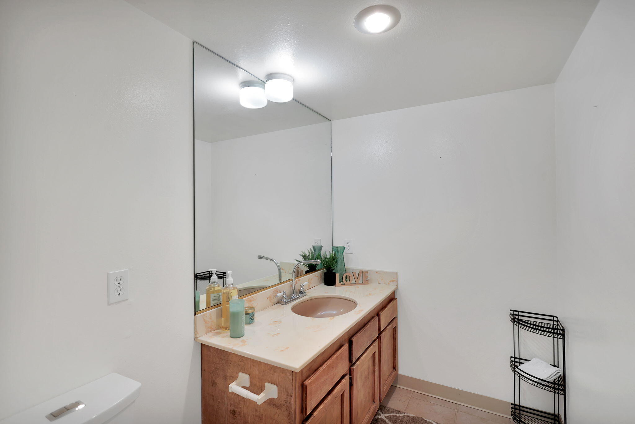13144 Bear Mountain Road Redding, CA 96003 - Photo 34 of 69 a bathroom with a sink vanity and a mirror