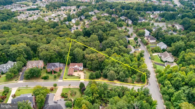 a front view of a house with a garden and trees