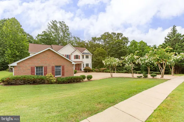 a view of a livingroom with lounge chair and windows