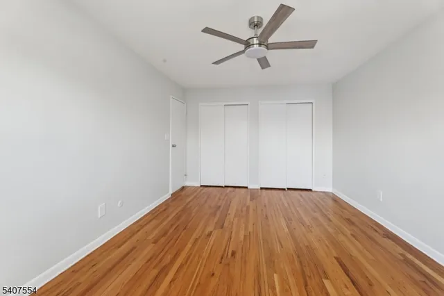 a view of a big room with wooden floor and closet area