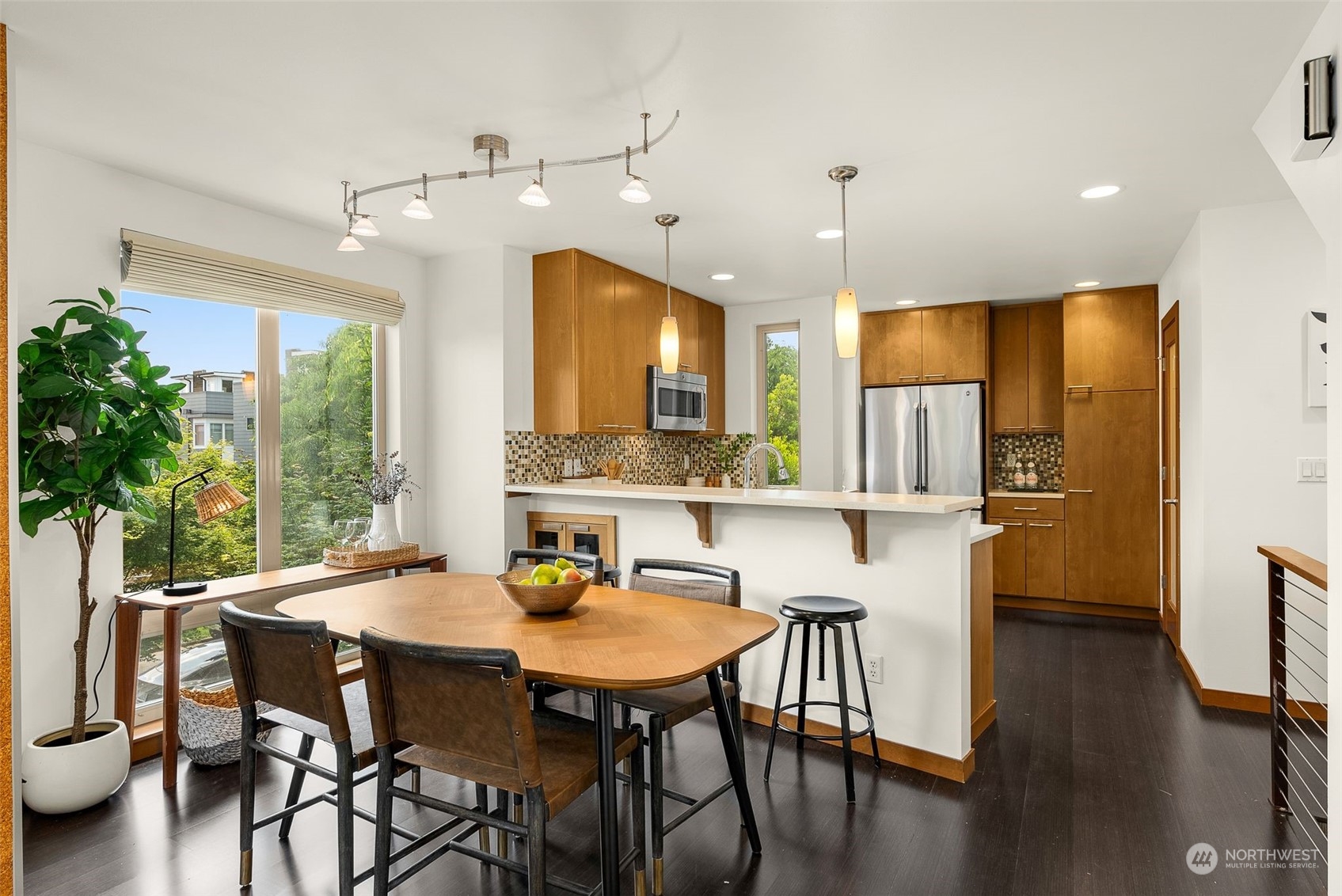 723 North 42nd Street Seattle, WA 98103 - Photo 14 of 27 a kitchen with stainless steel appliances a dining table chairs and couches