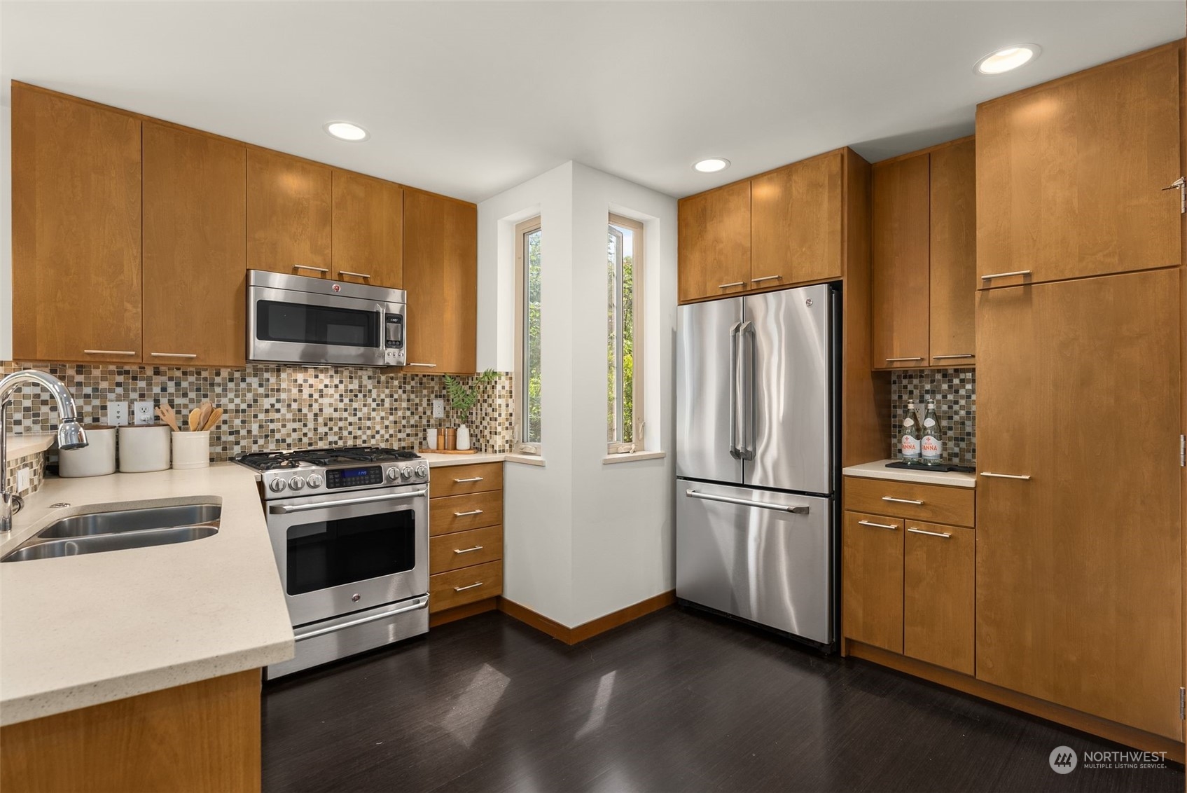723 North 42nd Street Seattle, WA 98103 - Photo 16 of 27 a kitchen with stainless steel appliances a refrigerator sink and microwave