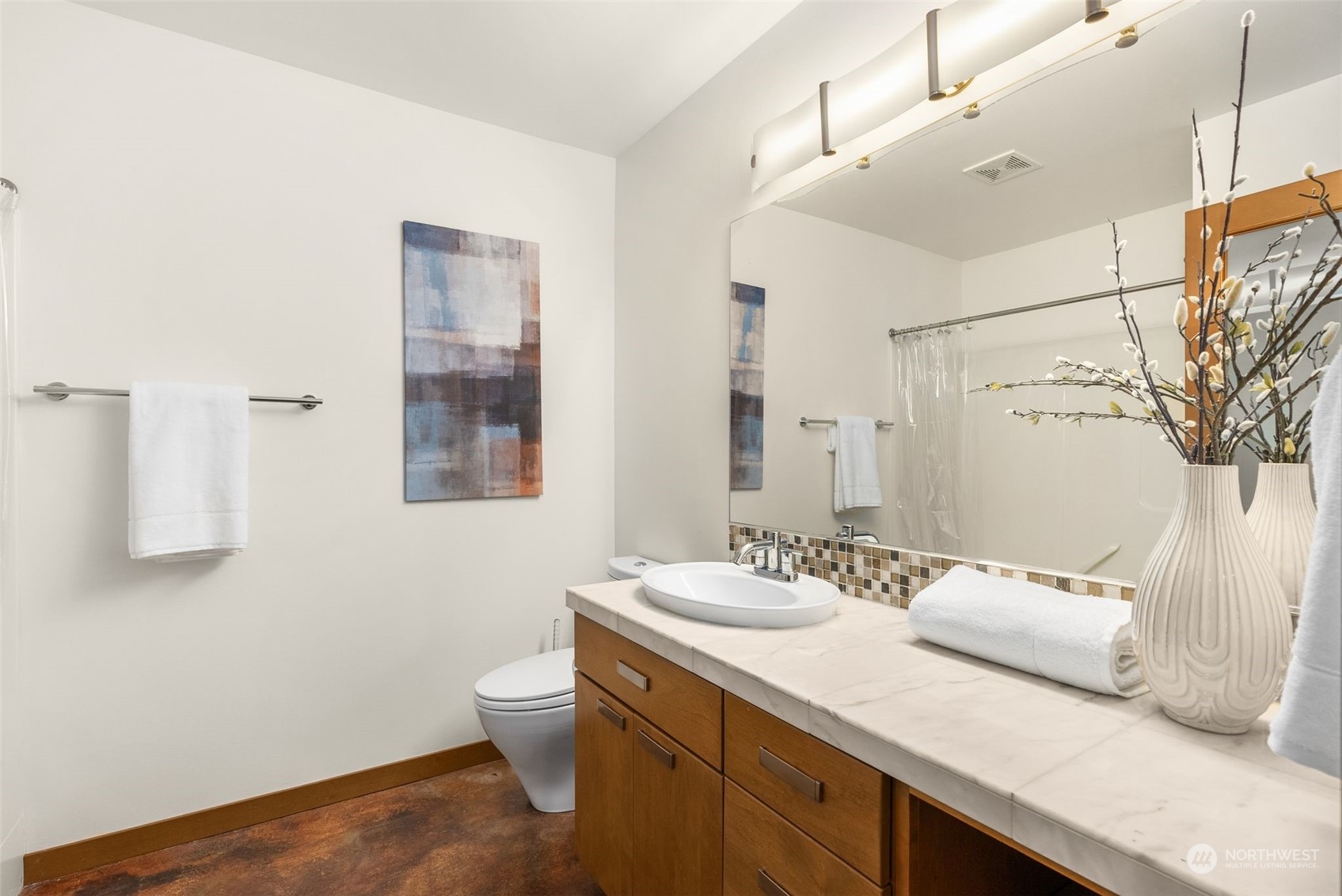 723 North 42nd Street Seattle, WA 98103 - Photo 7 of 27 a bathroom with a sink a toilet and a mirror