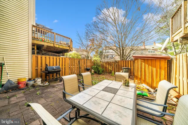 a view of a patio with a table and chairs