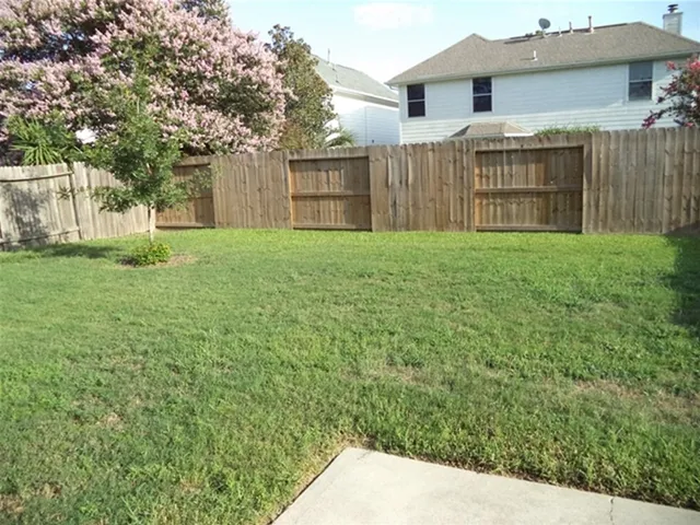 a view of a house with a backyard