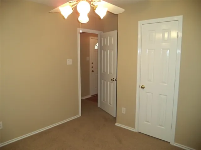 a view of a bathroom with a shower and a mirror
